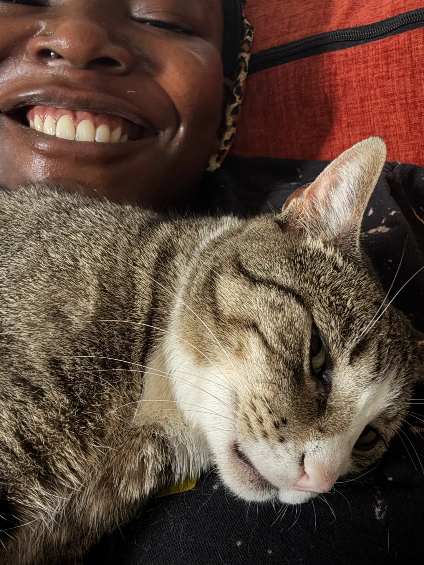 Khadijat holding Minx up next to her face