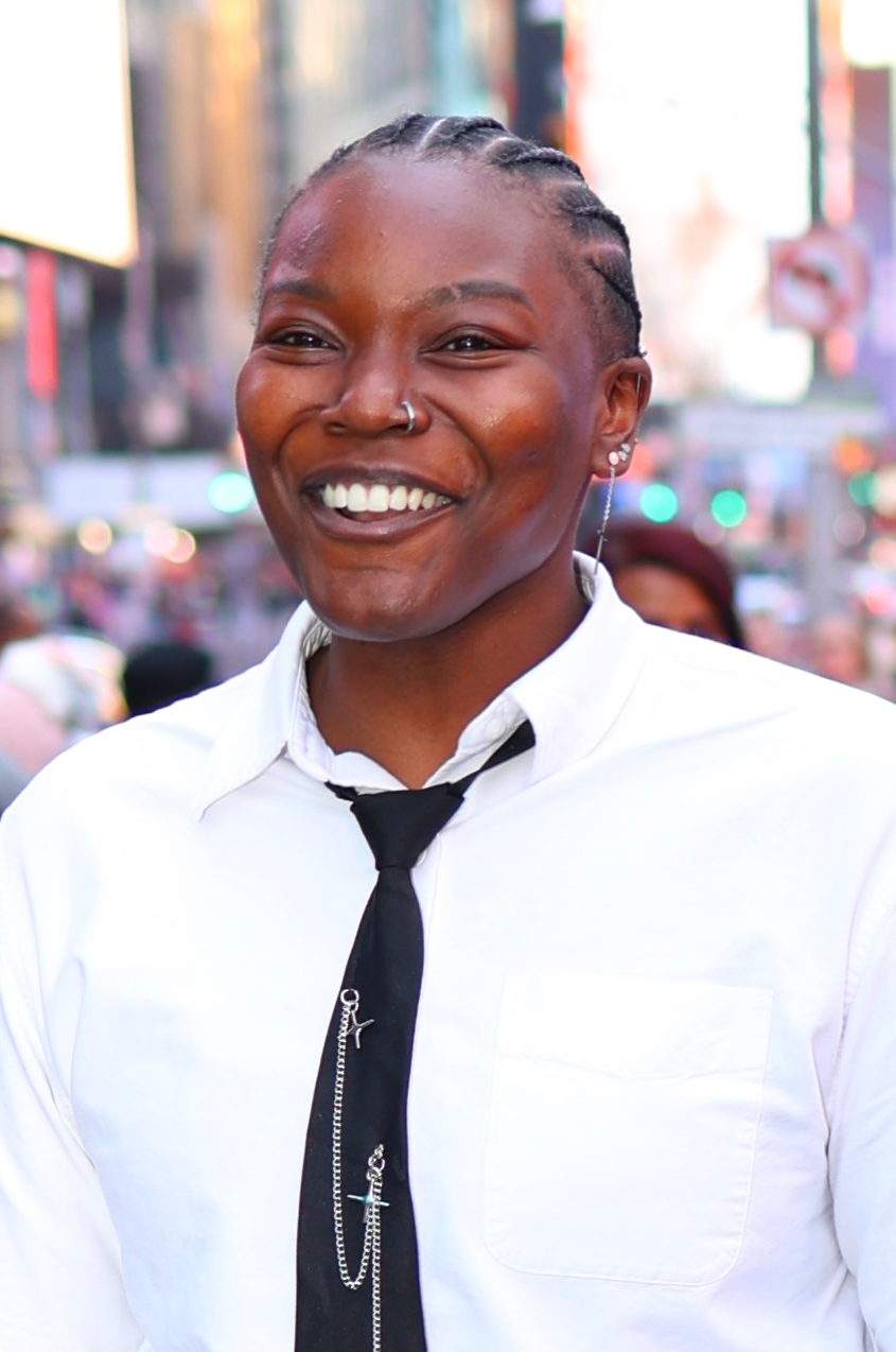 Khadijat Amoo, product designer, smiling in Times Square, New York City